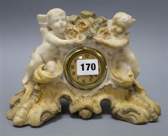 A painted alabaster cherub clock